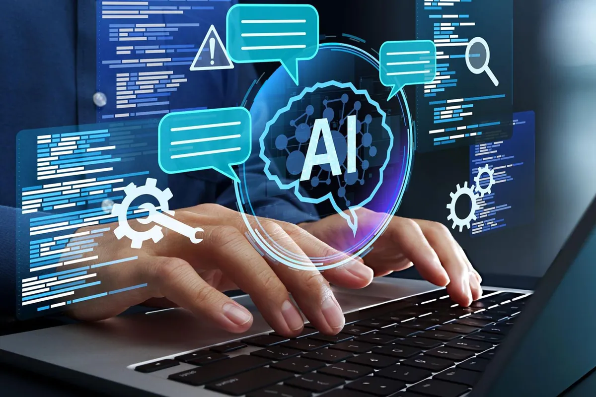 Hands typing on a laptop with an AI brain and chat bubbles floating above the screen